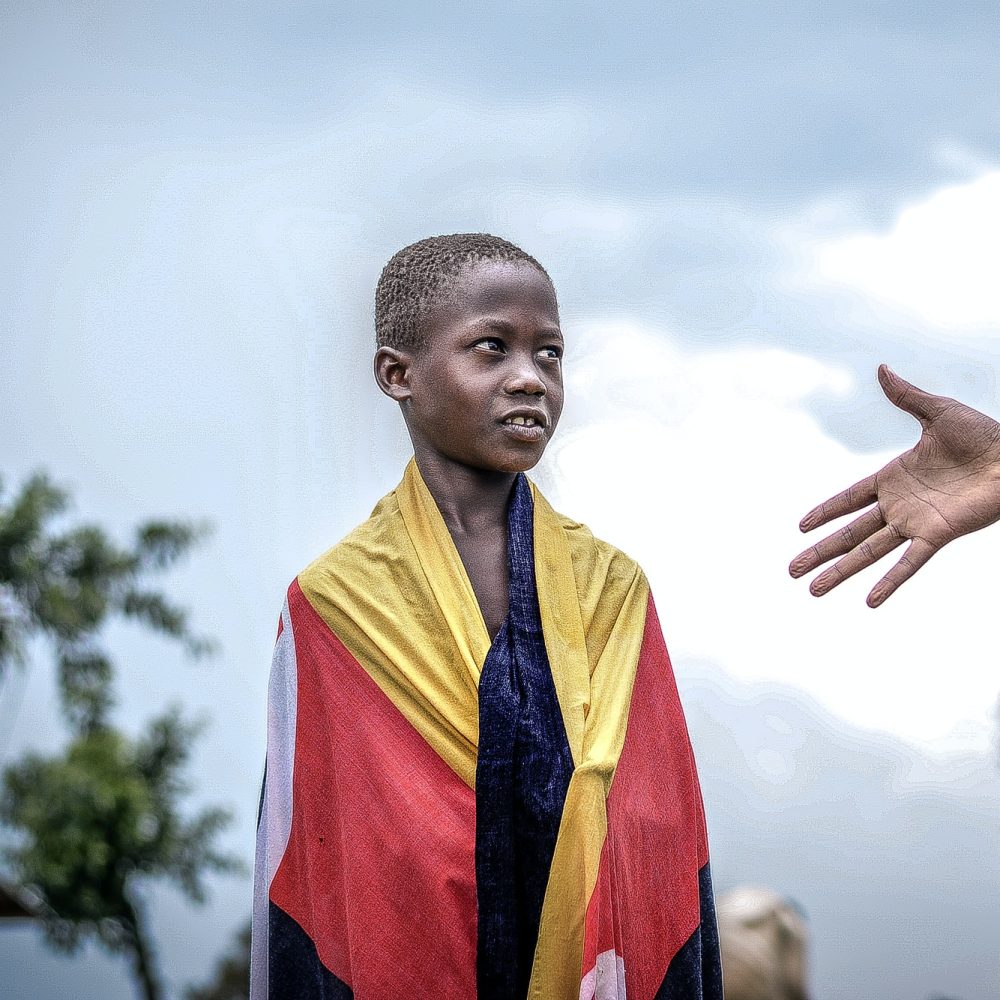 african-boy-looking-at-a-raised-hand.jpg